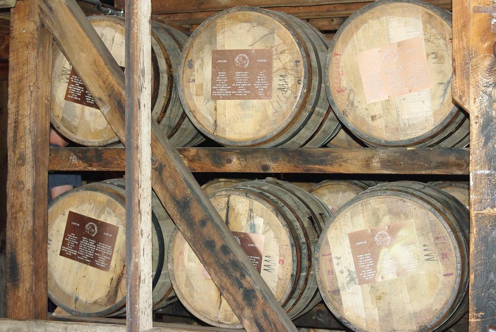 Rows of bourbon barrels aging in a Kentucky distillery
